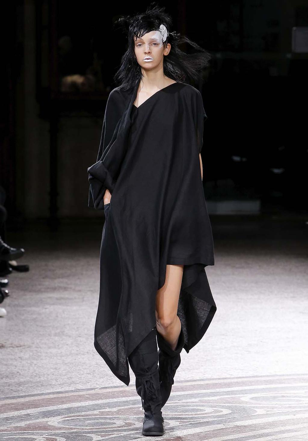 A black asymmetric tunic dress with a train, shown on the runway