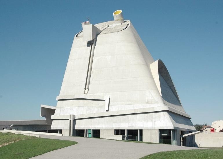 The conical concrete church of Saint-Pierre in Firminy against a clear sky