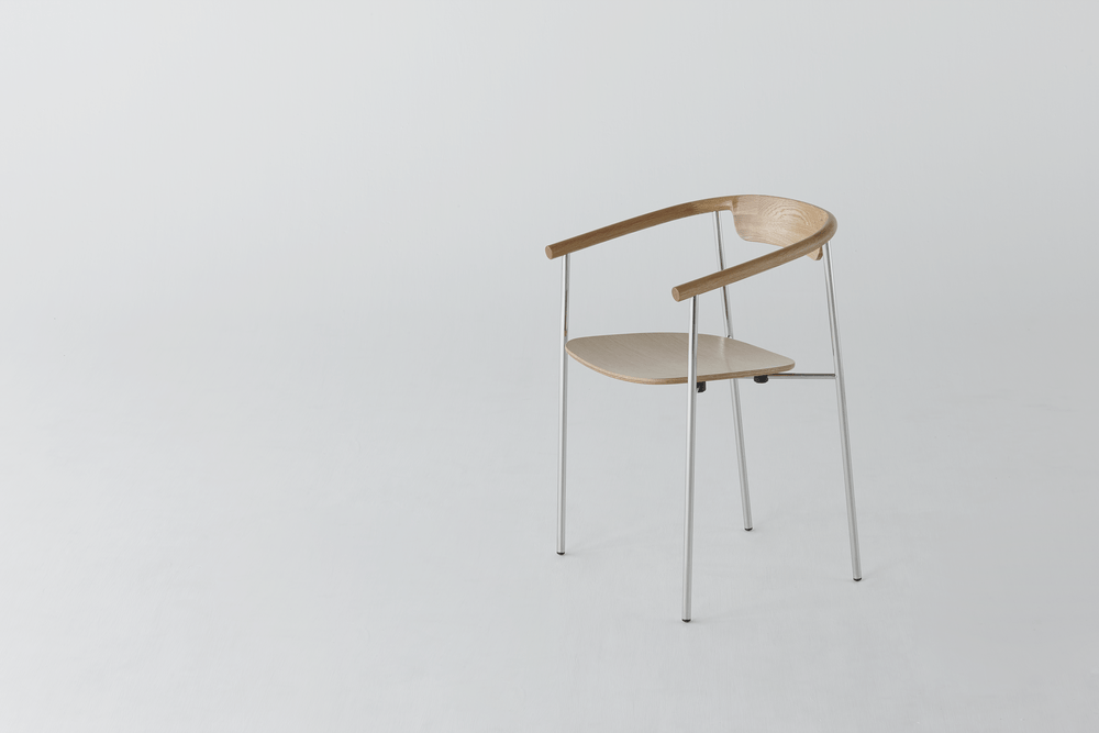 Chair with a wooden seat and back on a slender metal frame