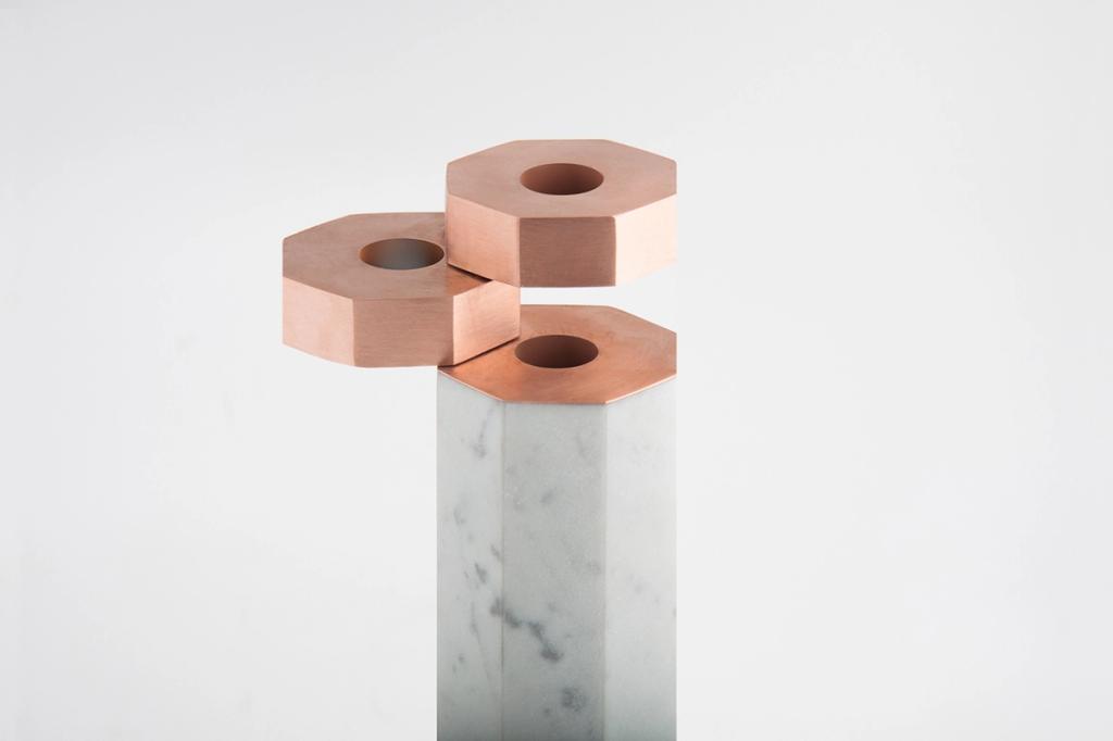 A vase made from a white marble hexagonal block with copper octagonal fittings, designed by Katya Tolstykh