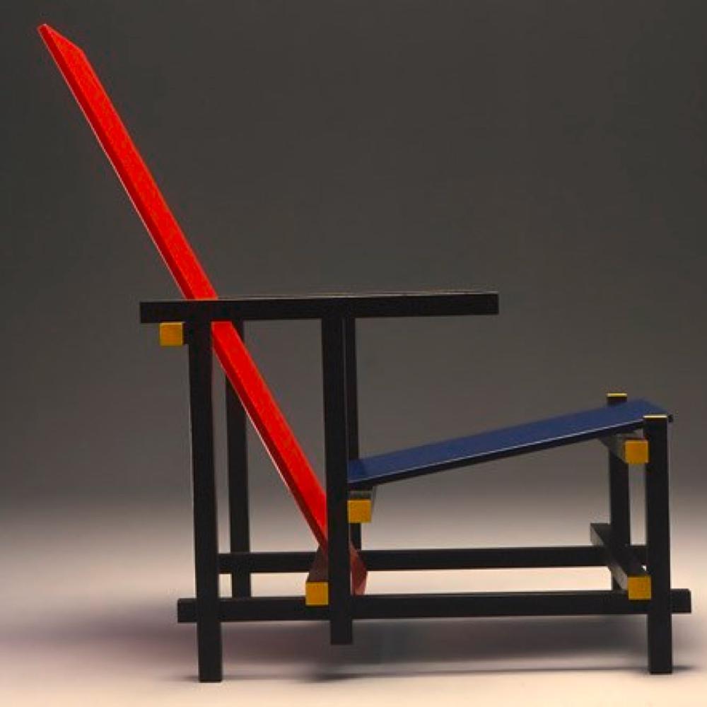 Gerrit Rietveld's Red and Blue Chair with a black frame, red back and blue seat, side view
