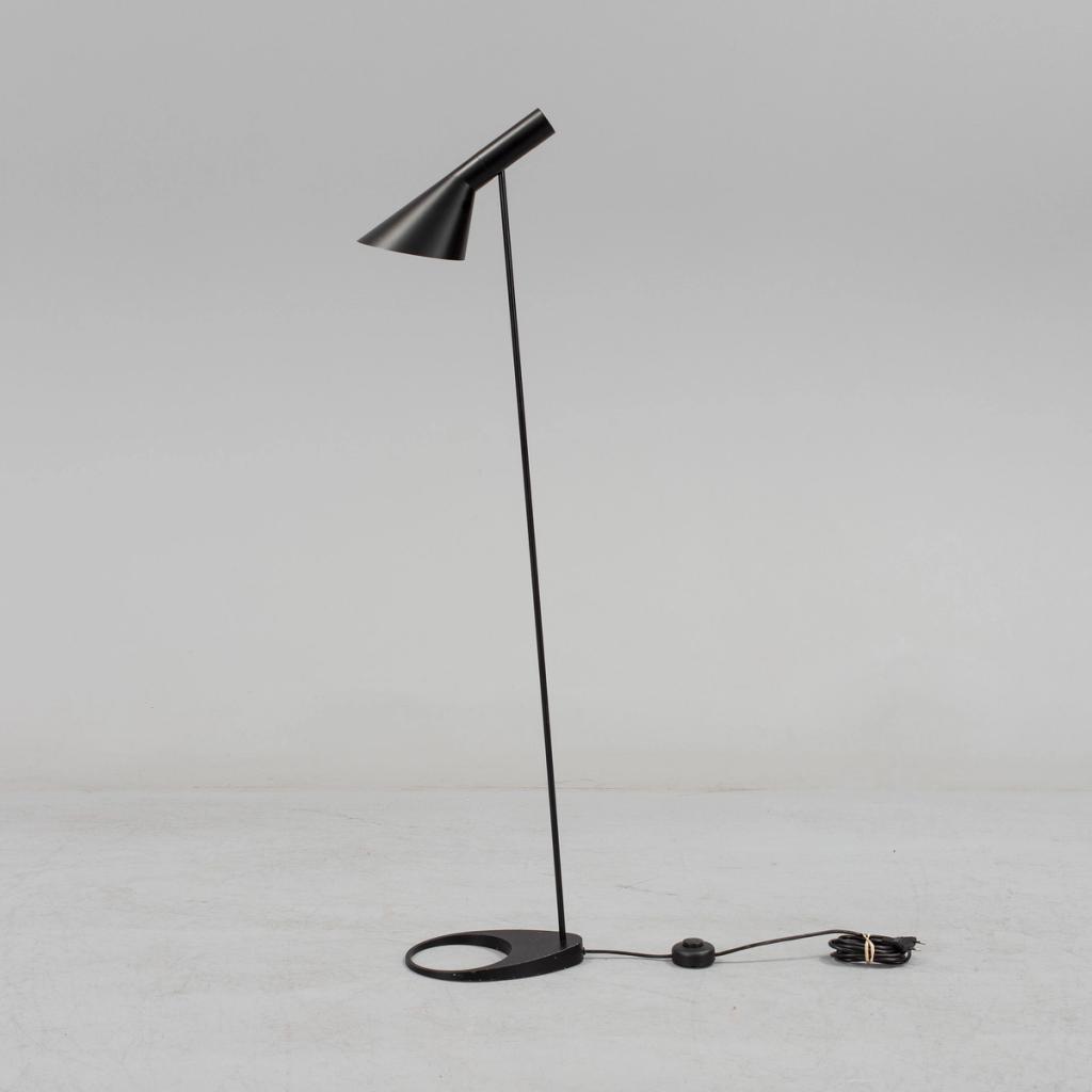 Arne Jacobsen's black AJ floor lamp, with an angled conical shade and a round base