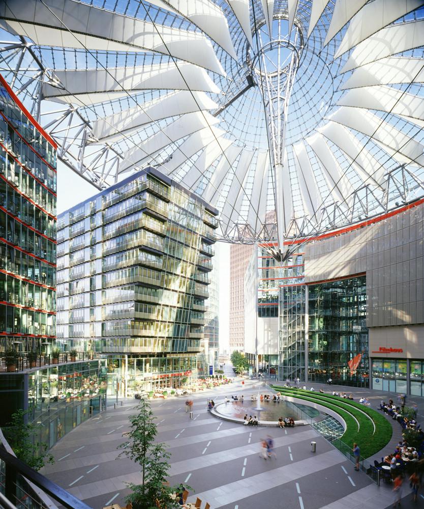 The central plaza of Sony Center beneath a fan-shaped tent roof of glass