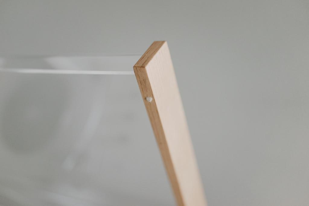 Close-up of the metal hinge and fixing screws of the lid's wooden frame