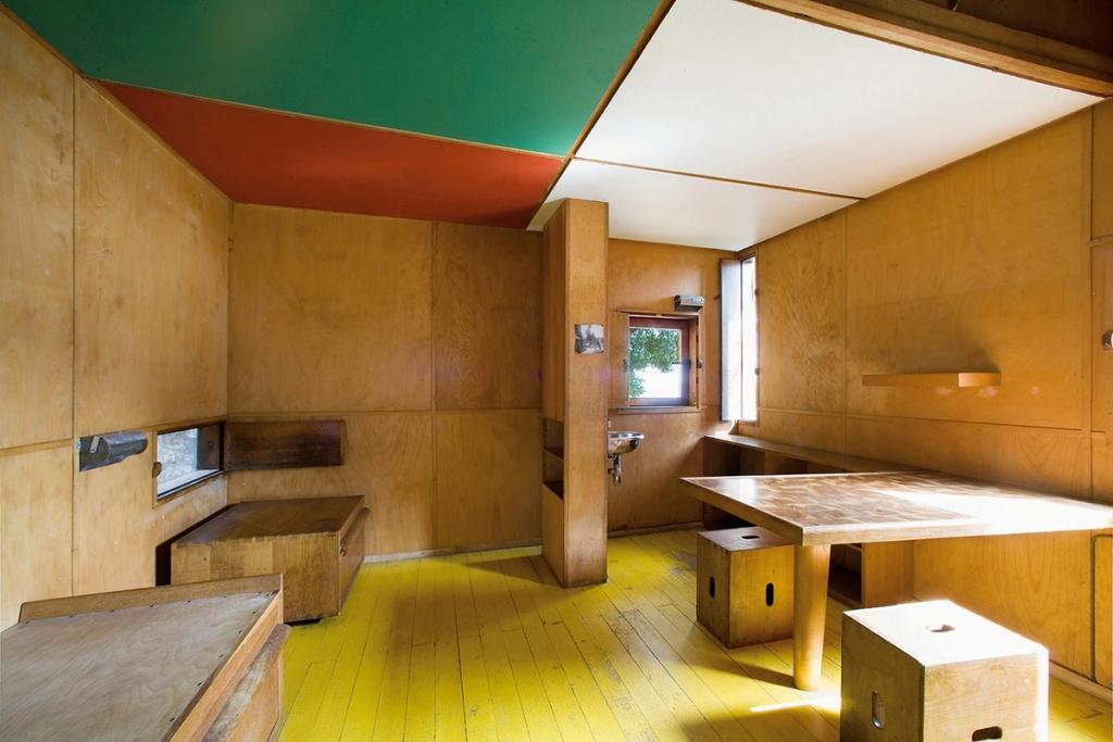 The Cabanon room with a coloured ceiling, yellow floor and plywood walls