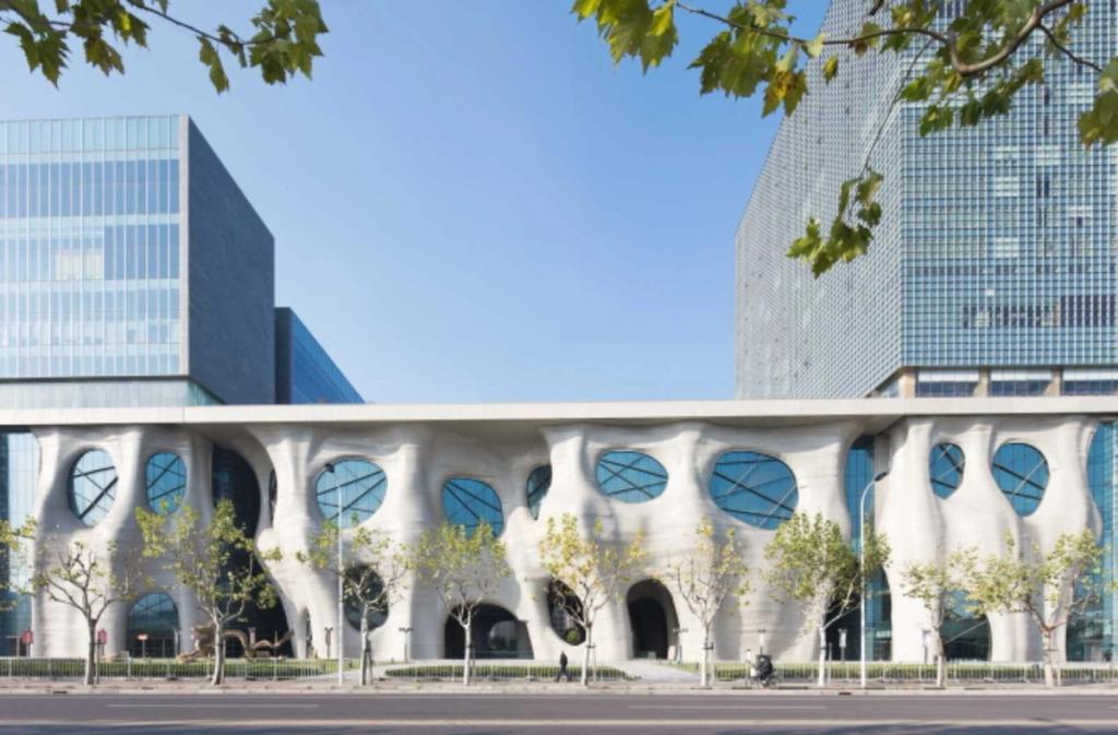 The facade of the Himalayas Center in Shanghai, with its sculptural white columns and circular windows