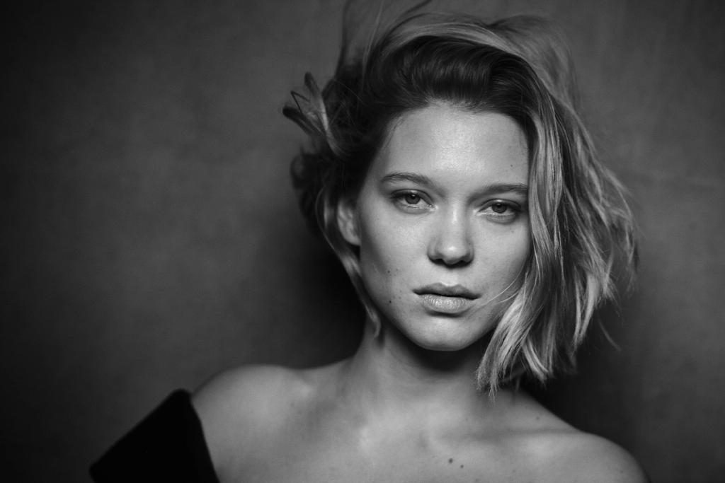 Black-and-white portrait of a young woman with tousled fair hair