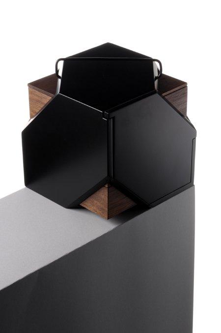 Black hexagonal trays with wooden insets on a dark sideboard