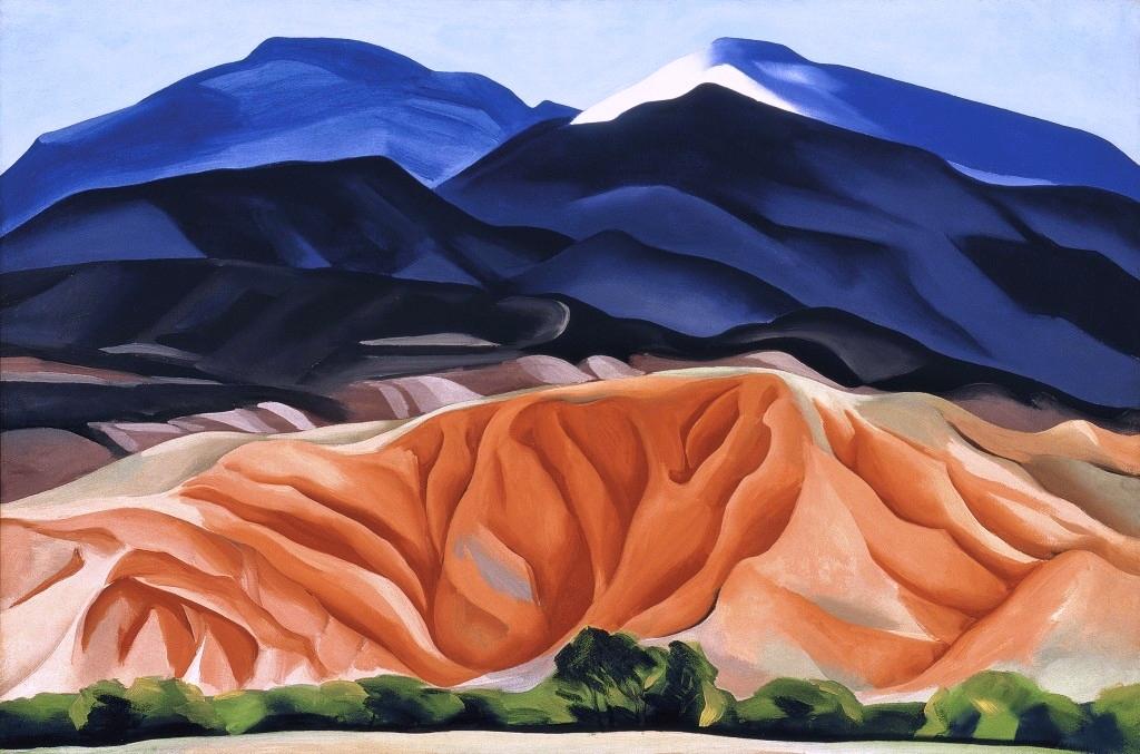 O'Keeffe landscape: blue mountains and the tawny folded hills of New Mexico