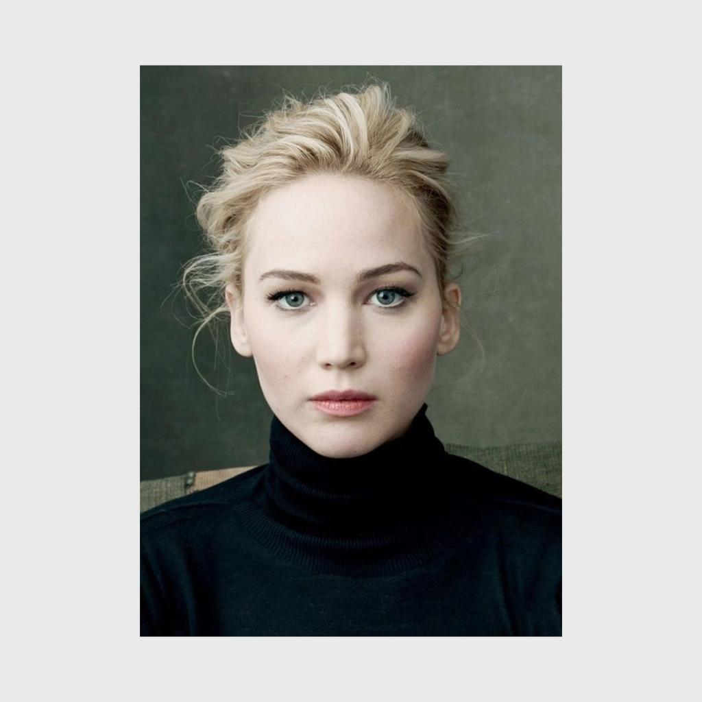 A colour close-up portrait of a blonde woman with blue eyes in a black turtleneck