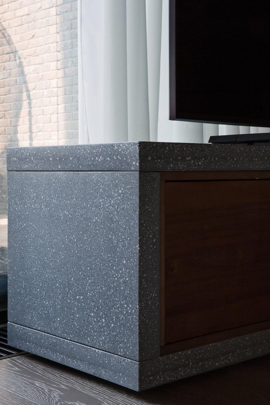 Detail of a grey terrazzo unit with a wooden front, close-up of the stone texture