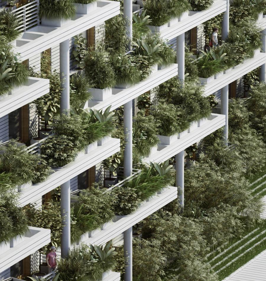 The facade of a white building with terraces covered in lush greenery and colonnades