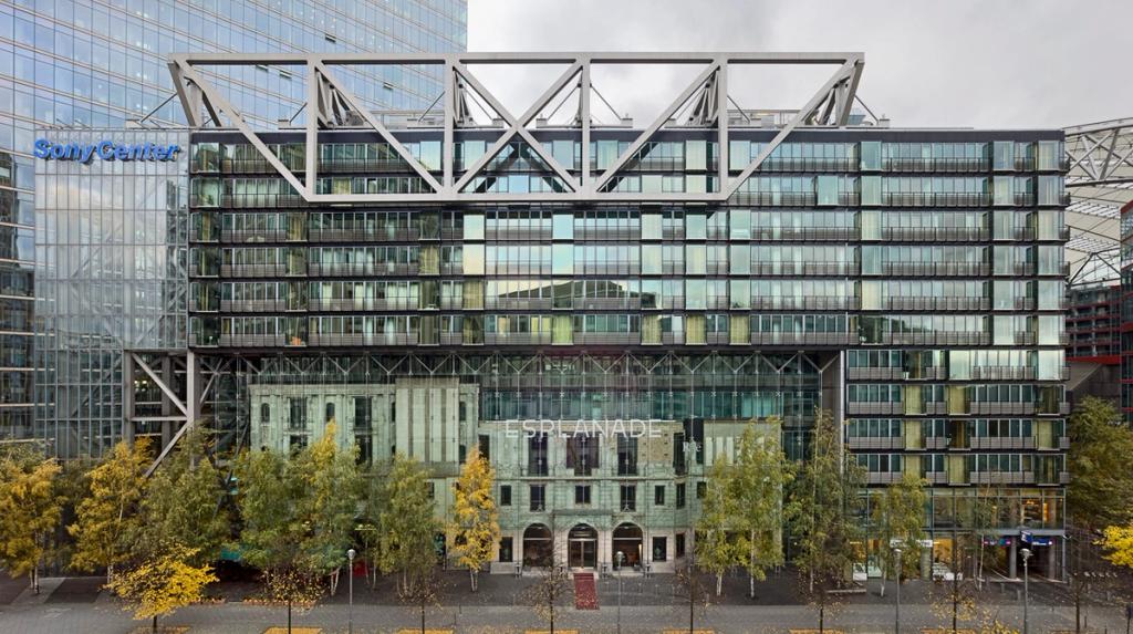 The façade of Sony Center with blue lettering and a metal truss above the Esplanade building