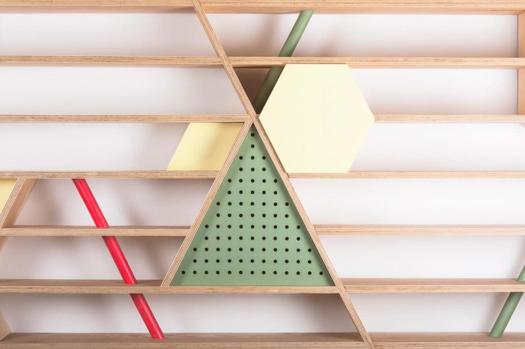 A detail of a plywood shelving unit featuring a coloured hexagon, a perforated triangle and a red rod
