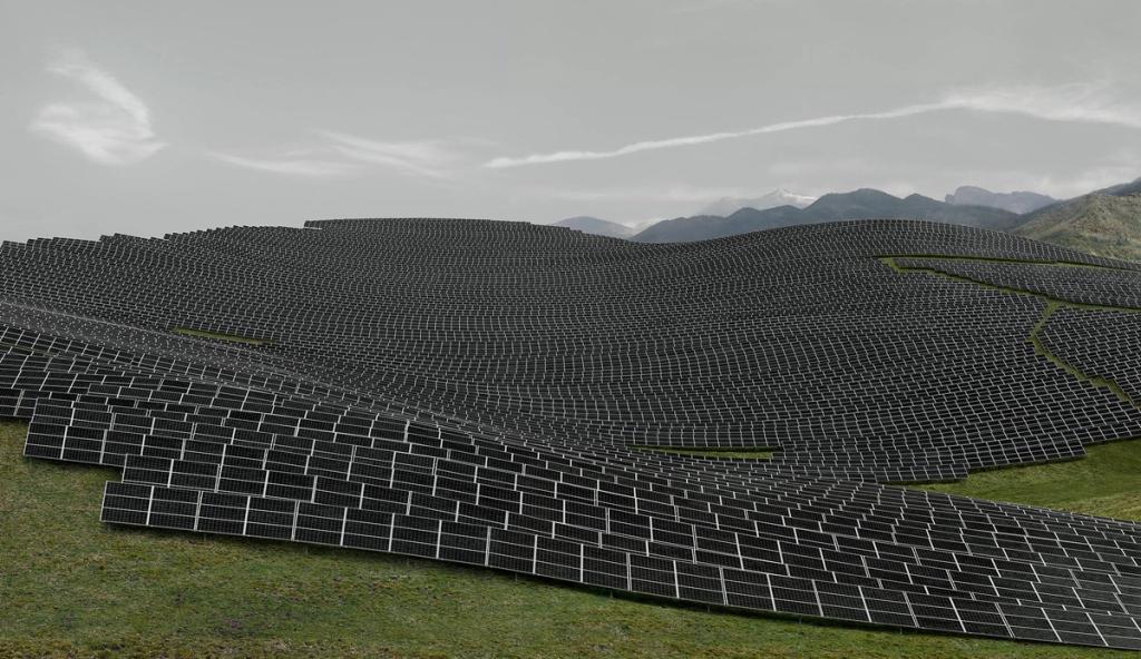 An enormous field of solar panels covering a rolling hillside stretching to a mountain range on the horizon