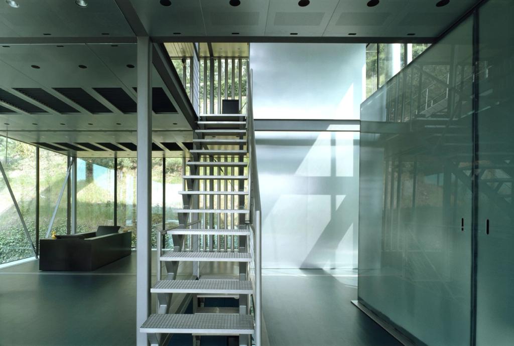 Interior of house R-128 with an open staircase and a frosted glass partition