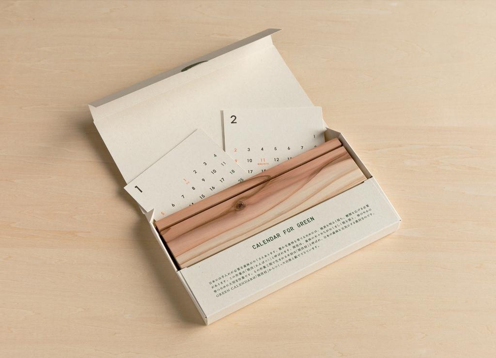 Wooden desk calendar with monthly cards in a box