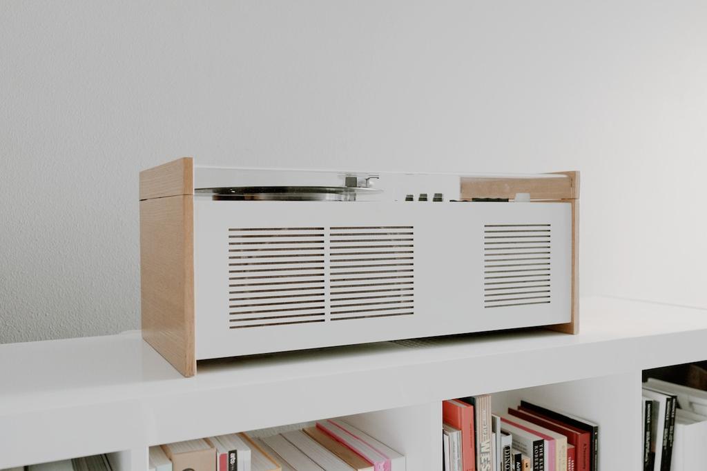 The Braun SK55 record player with its wooden cabinet on a shelf above a bookcase