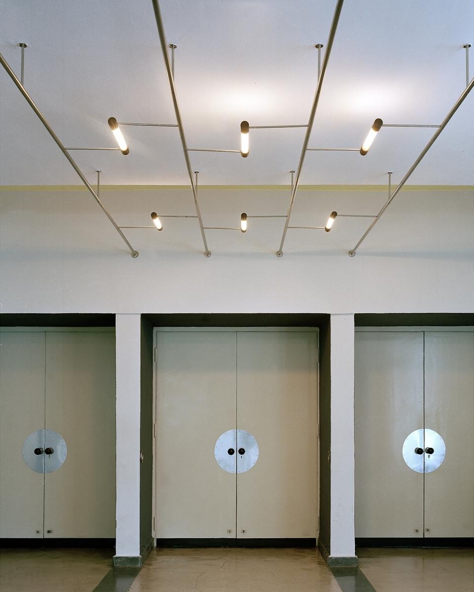 The Bauhaus lobby with tubular ceiling lights and doors fitted with circular escutcheons