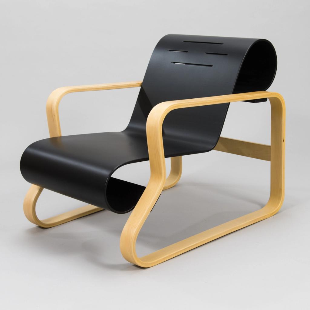 Alvar Aalto's Paimio Chair with a black bentwood seat and a frame of light birch plywood