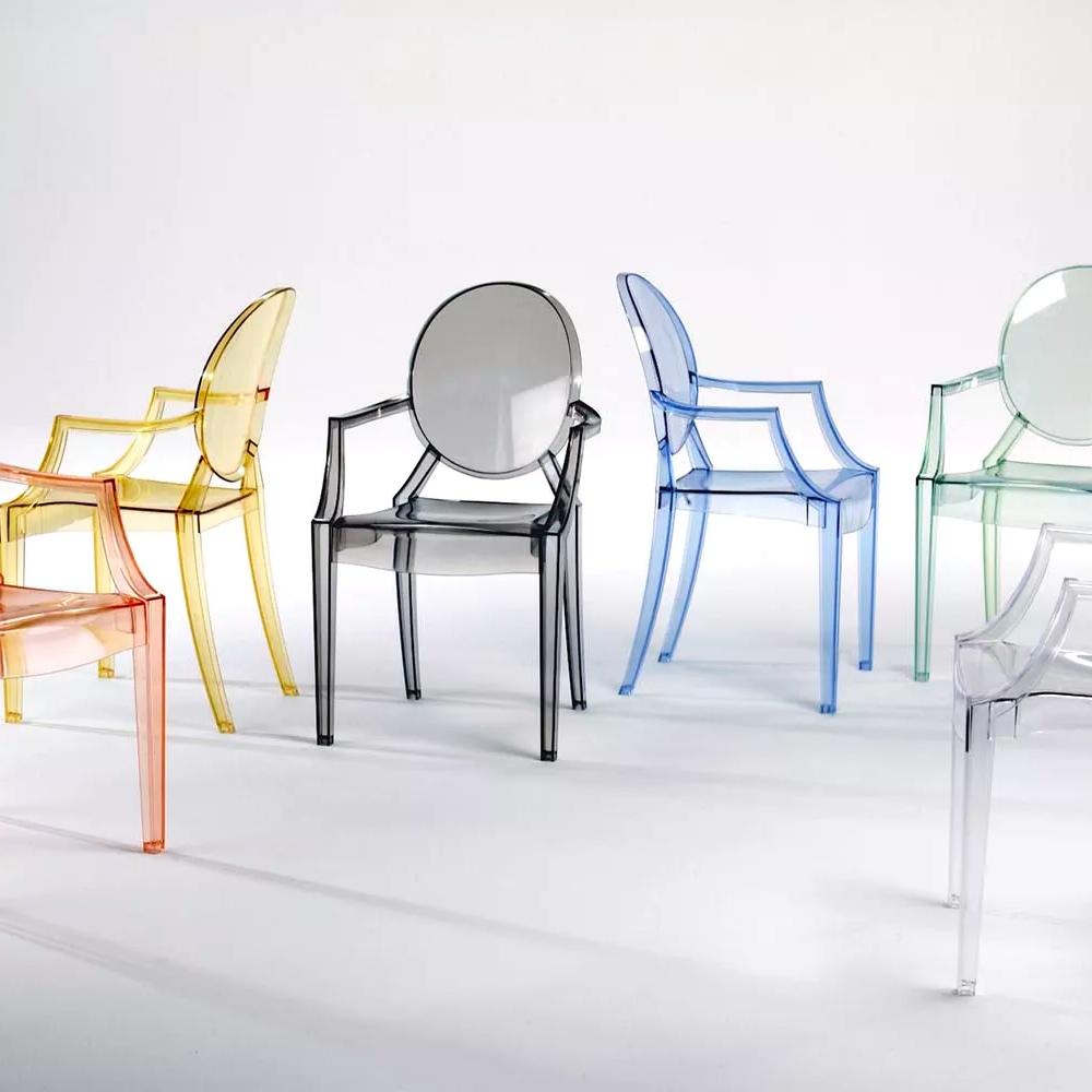 A row of Starck's Louis Ghost chairs in tinted transparent polycarbonate in various colours