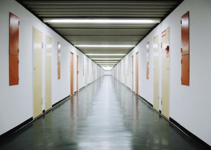 A long internal corridor of the Berlin residential complex lined with rows of apartment doors