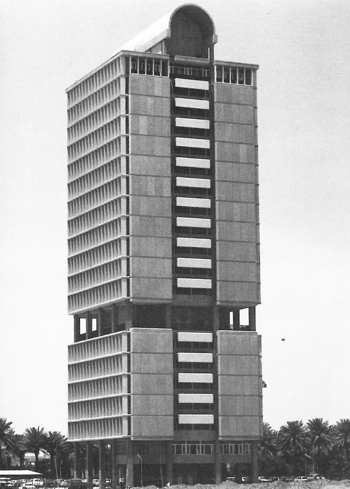 The multi-storey university tower in Baghdad, with a regular grid of windows and a cylindrical structure on the roof