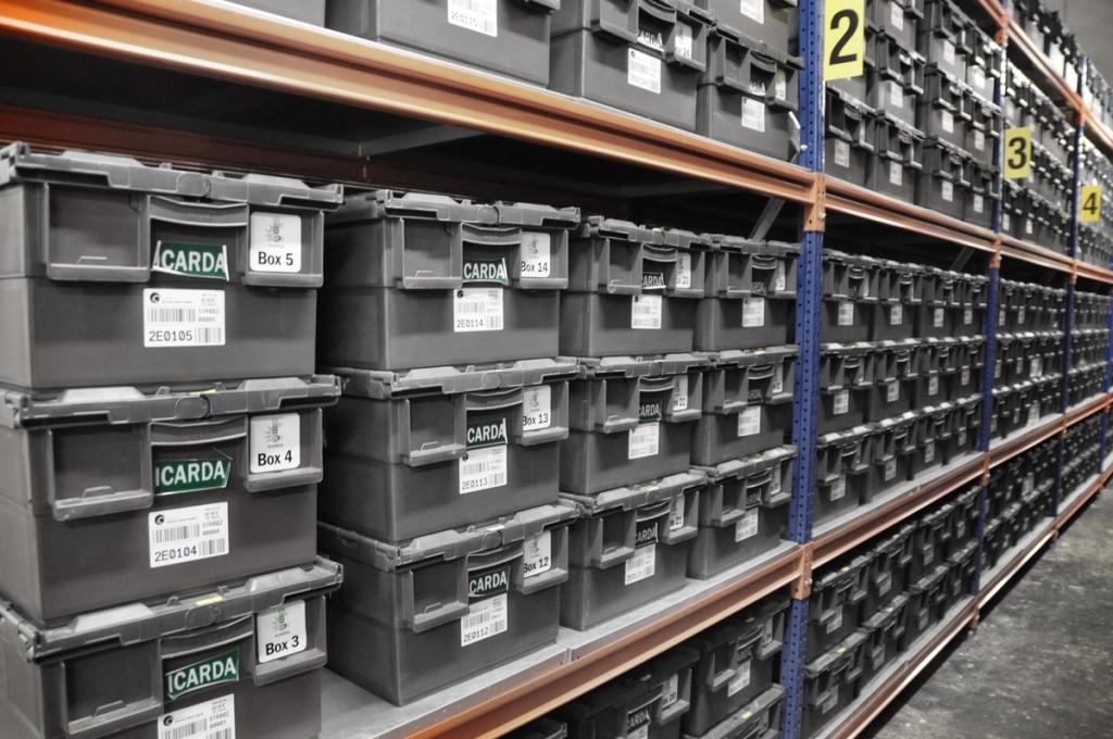 Rows of grey plastic containers labelled ICARDA on the shelving units of the seed vault