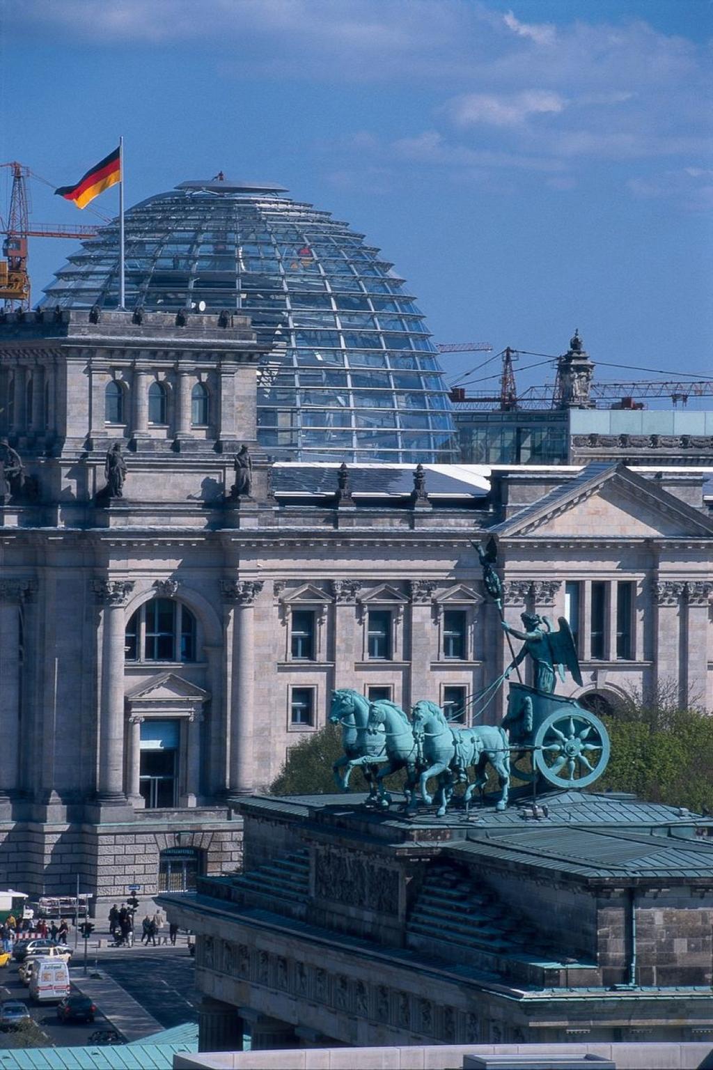 The Reichstag's glass dome above the historic building, with the German flag and the Quadriga