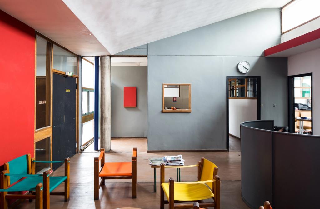 The communal lobby of the Unité d'Habitation in Marseille, with multicoloured wooden chairs