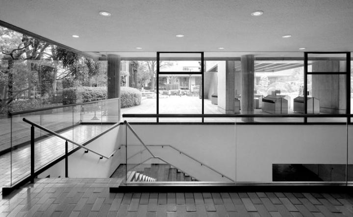 The glazed interior of the National Museum of Western Art with staircase and a view into the garden