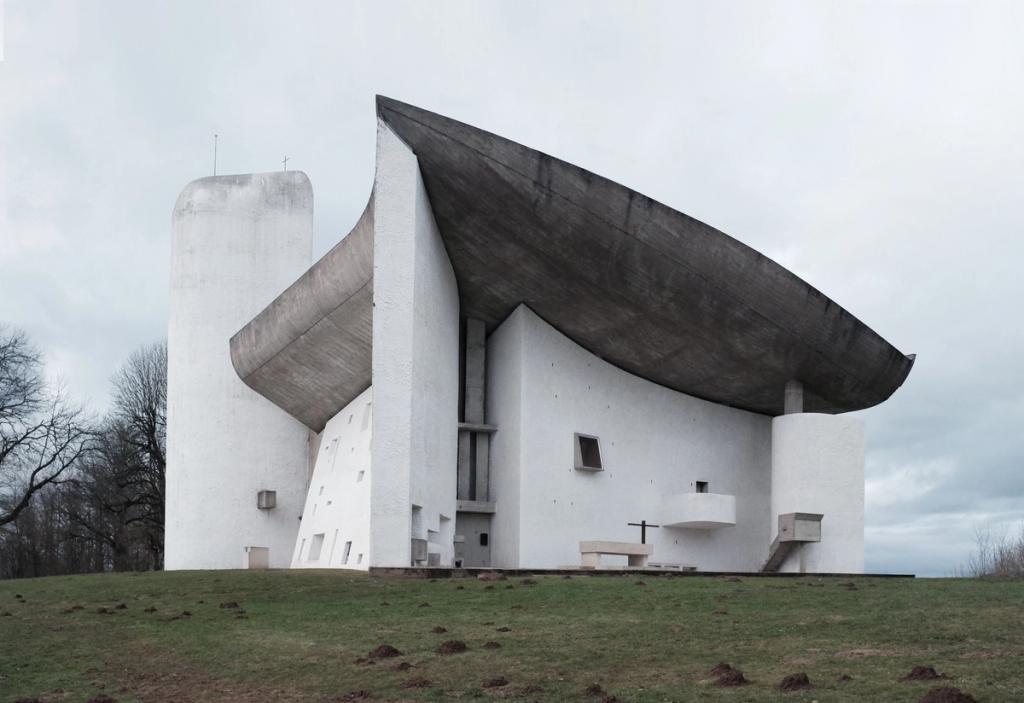 The Chapel of Notre-Dame-du-Haut at Ronchamp, with white walls and a curved concrete roof