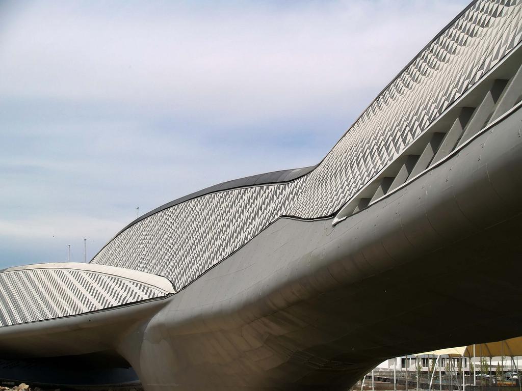 A close-up of the streamlined body of the Zaragoza bridge-pavilion, showing its grey triangular-scale cladding