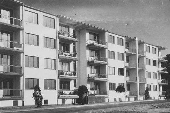 A white 1920s apartment block with rows of balconies along the facade