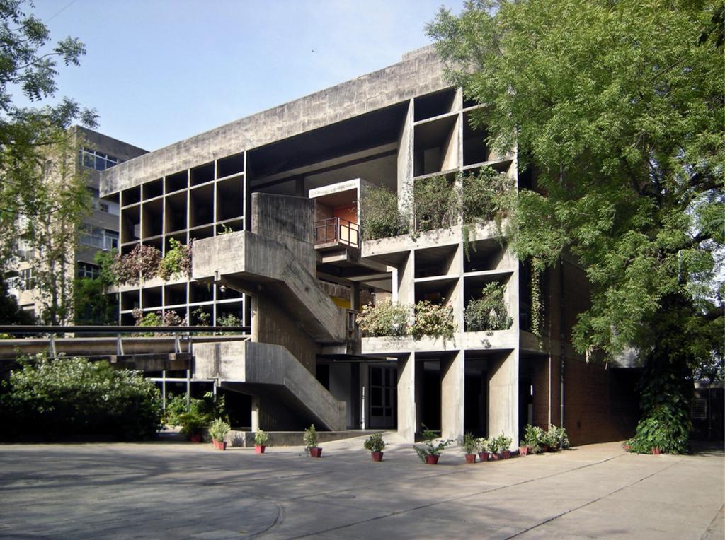 A concrete building in Chandigarh with planted loggias and an exterior staircase