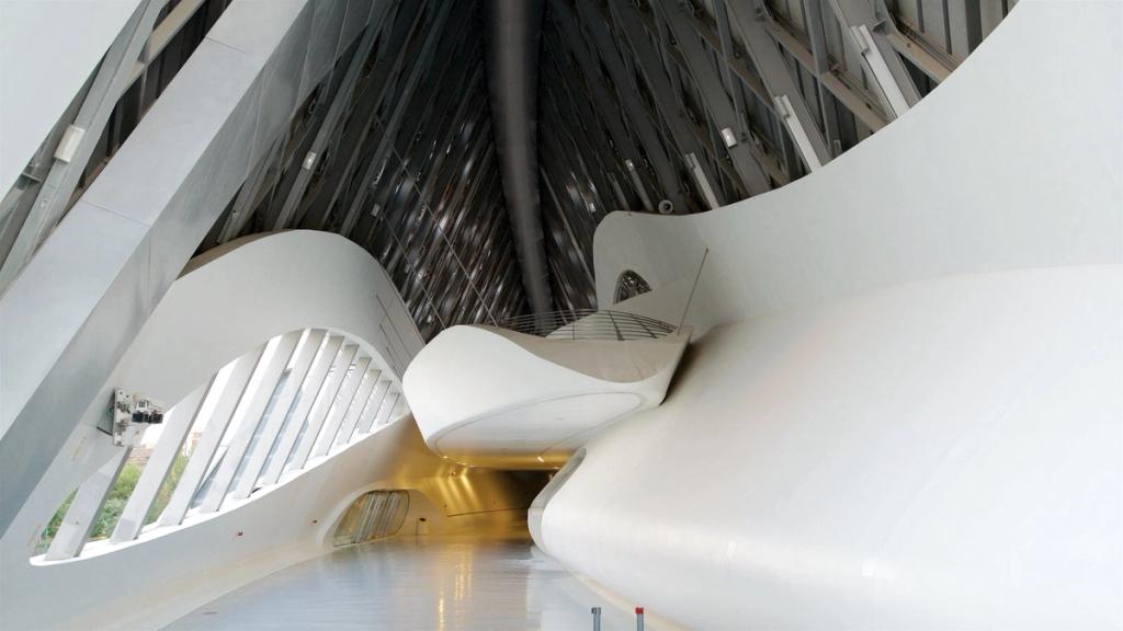 Interior of the Zaragoza bridge-pavilion: gently curved white volumes and warm corridor lighting