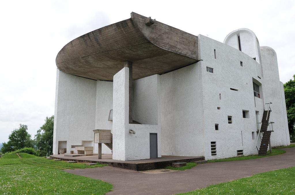 The Chapel of Ronchamp, an overhanging concrete canopy above the open-air pulpit