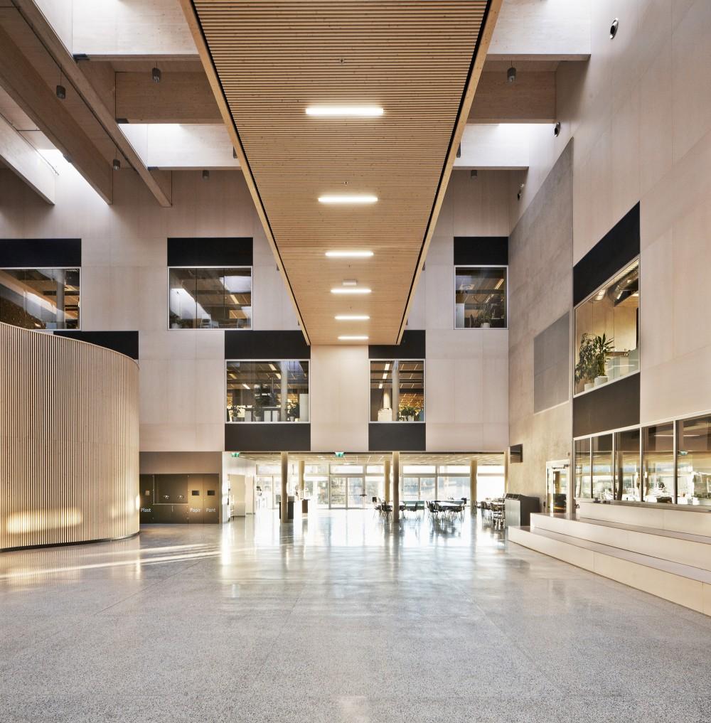 The spacious, light-filled lobby of Nord-Osterdal school with timber finishes and galleries