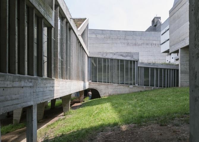 The inner courtyard of Couvent Sainte-Marie de La Tourette with concrete walkways and glazed surfaces