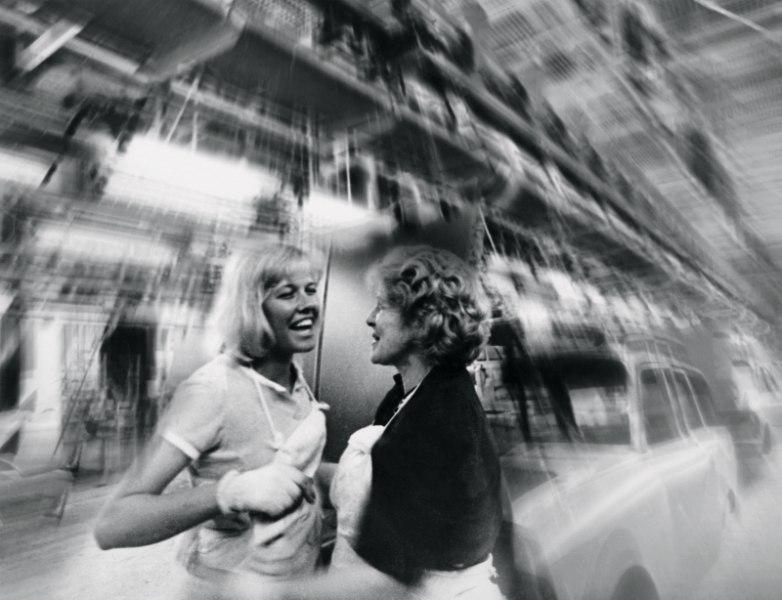Two children laugh against the sky, the shot taken with a dynamic blur along the edges
