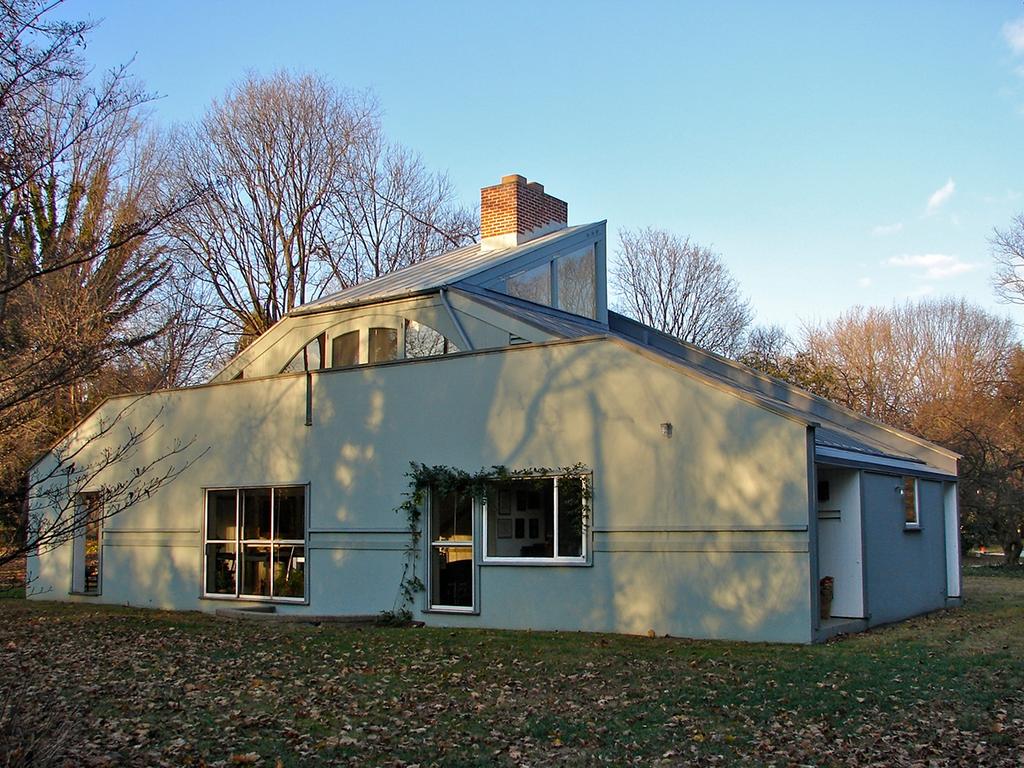 The rear façade of the Vanna Venturi House, with its central chimney and sloping roof