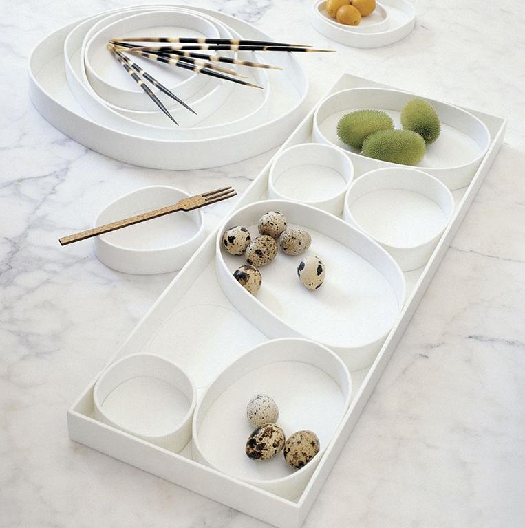 White round Vertigo trays on marble, with quail eggs and porcupine quills