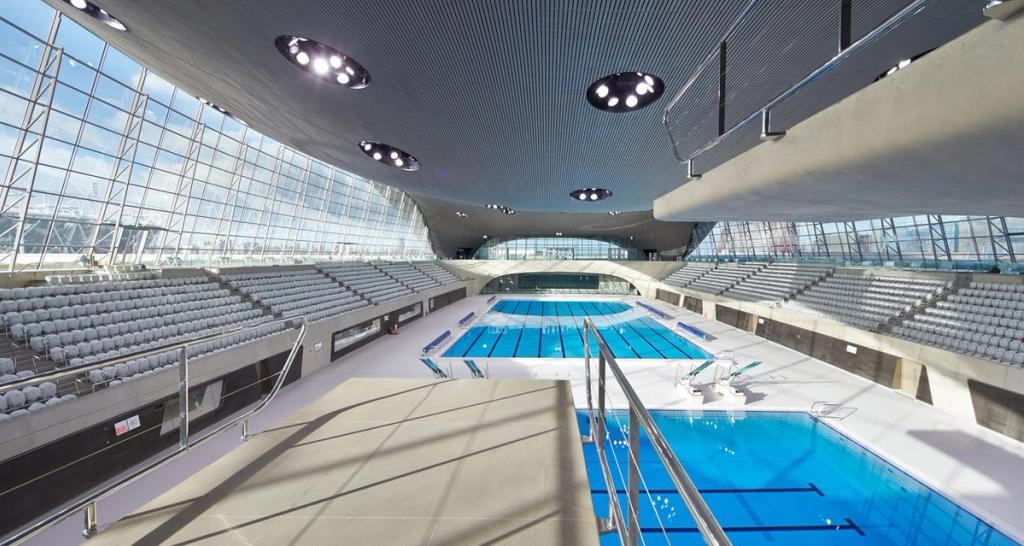 Interior of the London Aquatics Centre featuring two pools and spectator stands
