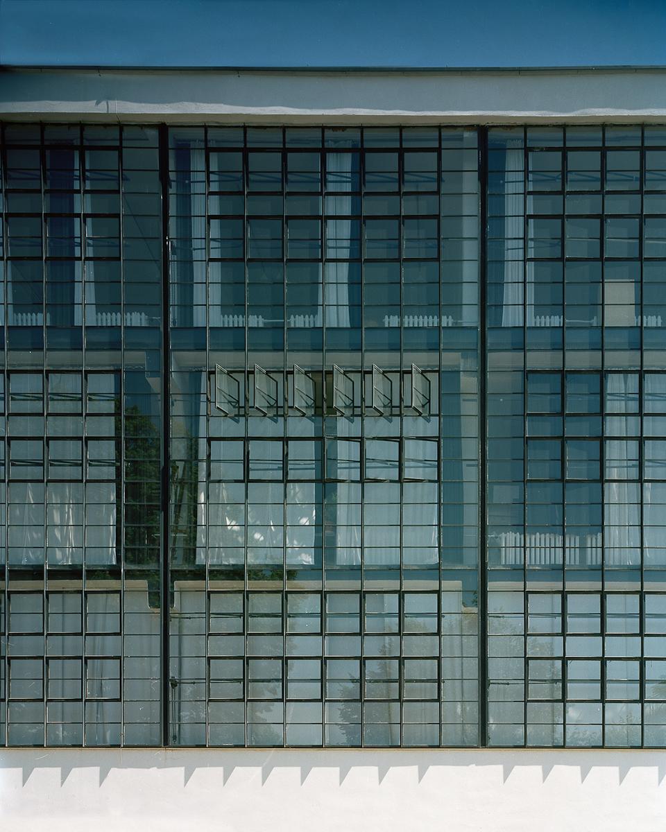 A detail of the continuous glass façade of the Bauhaus workshops in Dessau with open transom windows