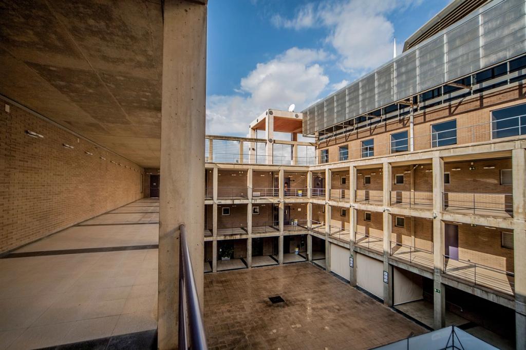 The inner courtyard of the brick-and-concrete complex, with multi-tiered open-air galleries