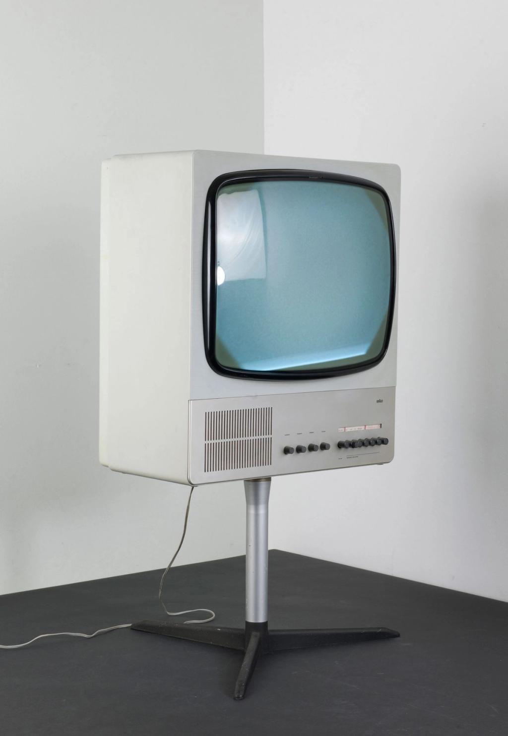 Braun television in close-up, showing the speaker grille and a row of rotary knobs below the screen