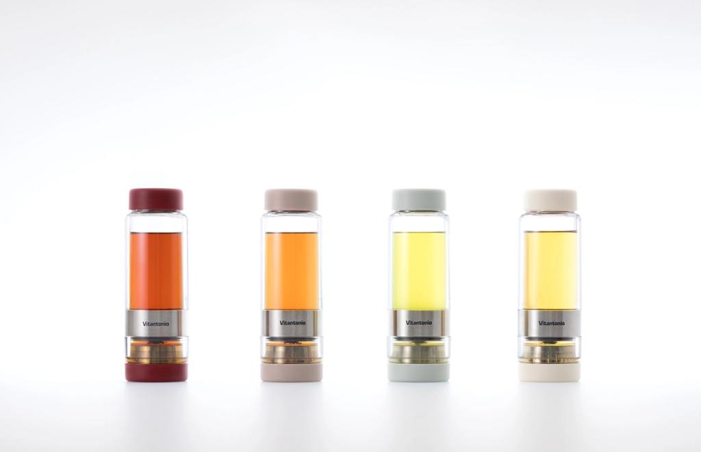 Four Vitantonio glass brewing bottles filled with drinks in different shades