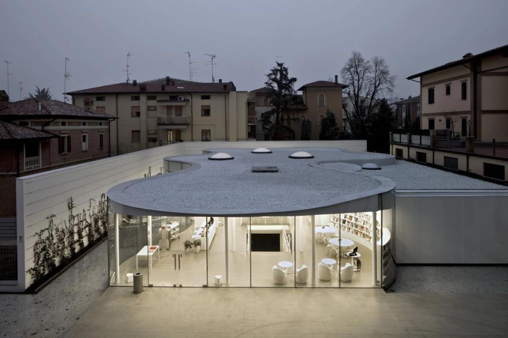 Aerial view of the MABIC Library's curved glass form with a white gravel roof