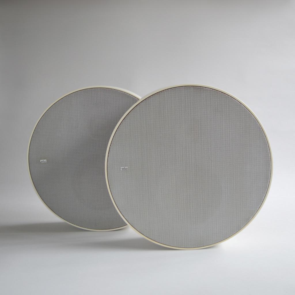 Close-up of a round Braun electrostatic speaker — metal mesh surface with logo
