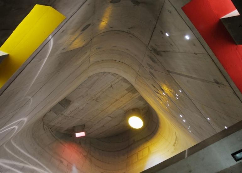 View from below of the curved concrete vault of Saint-Pierre church, with a circular oculus